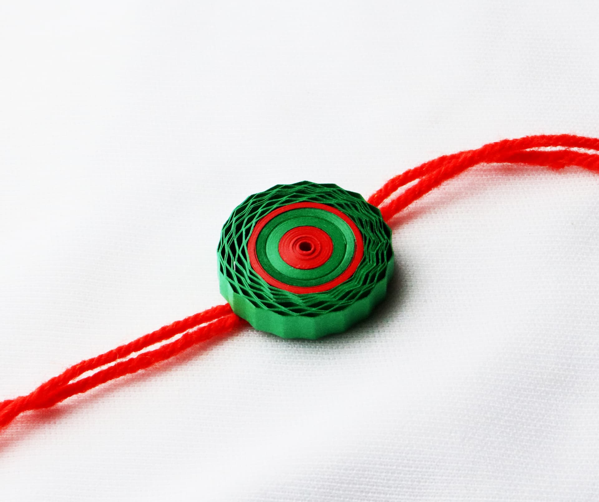 Eco-Friendly Spiral Quilling Rakhi with Red Thread ( 12 Pcs )