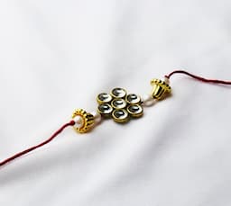 Elegant Kundan Floral Rakhi with Pearl Accents on Red Thread ( 12 Pcs )